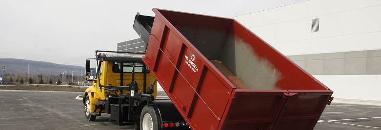 Mr. Waste truck dropping off a bin.